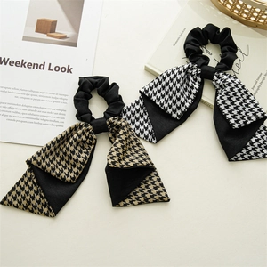 Detailed view of French vintage houndstooth bow scrunchies with long fabric ribbons