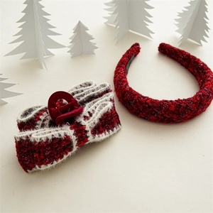 Close-up of red and black tweed headband and bow hair claw clip set for winter