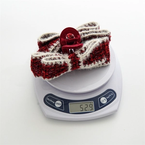 Winter wine red bow hair claw clip in plush fabric weave weighing 52.9g on scale