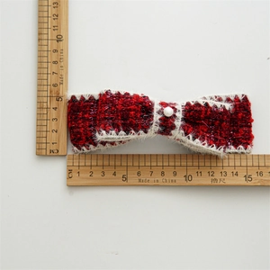 Tweed burgundy bow hair clip with faux pearl detail and measurement scale shown