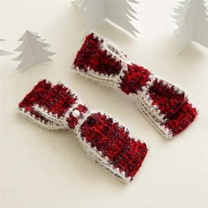 Detail of red tweed bow hair clips with faux fur trim and pearl accent in winter style
