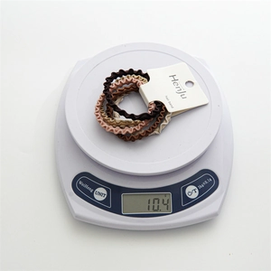 5-pack elastic wavy hair ties in earth tones like brown and beige displayed on scale