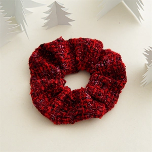 Detail of red and black tweed scrunchie with metallic glitter silk and textured fabric