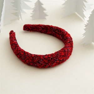 Close-up of a red tweed wide headband on a festive minimalist background