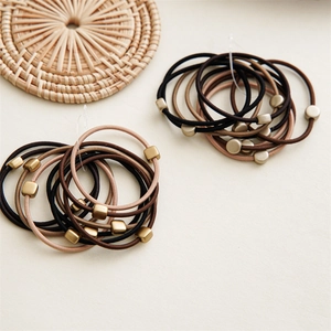 Close-up of matte metal beads on high-elastic earth tone hair ties and scrunchies