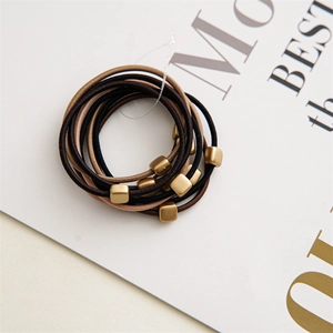 Detail of 10-piece hair tie set featuring coffee tones and matte gold square beads
