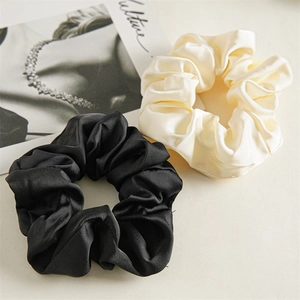 Elegant French satin scrunchies in black and beige silk texture for stylish hair styling