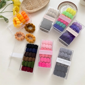 Detail view of thick seamless high-elasticity hair ties with wave texture in boxes