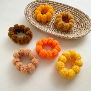 Detail of 6 thick seamless high elasticity hair ties in warm plush spiral textures