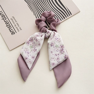 Detail showing purple floral chiffon double-layer ribbon hair tie with pleated texture