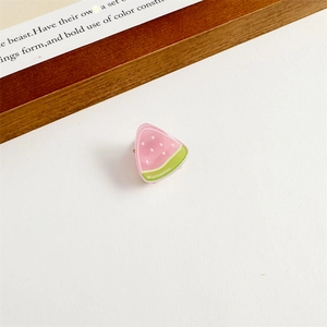Détail d'une mini pince à cheveux pastèque en résine rose avec bordure verte fruitée