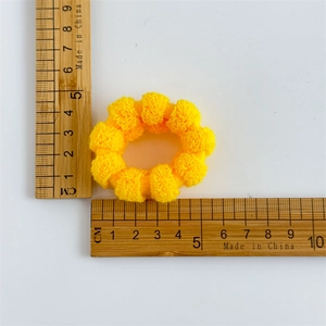 Close-up of yellow elastic towel hair ring showing 4.5cm size measurement with ruler
