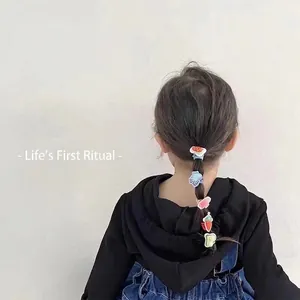 Cute cartoon fruit and bear hair accessories set shown on a little girl's braided hairstyle