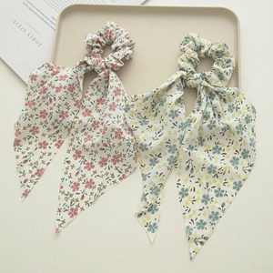 Detail of floral chiffon hair scrunchies with long ribbons in pink and blue colors