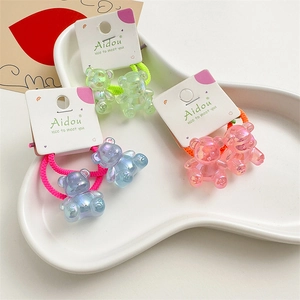 Detail of cute acrylic 3D bear hair ties in iridescent green, pink and gradient blue