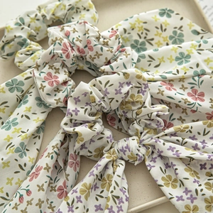 Set of floral ribbon scrunchies in pastel colors with elegant hanging fabric streamers