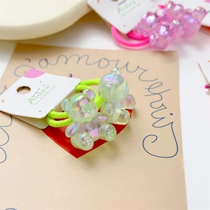 Detailed macro view of pearlescent resin bear charms on high-elasticity braided hair ties
