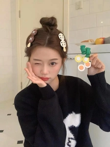 Detailed view of creative cartoon food hair clips like fried egg and lotus root