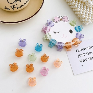 Macro shot of colorful transparent mini rabbit hair clips with shiny glitter details