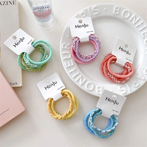 Five-pack of candy-colored elastic hair ties with textured woven design on a display card