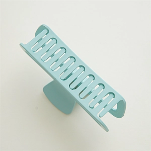 Close-up of a mint green matte shark hair claw clip for thick hair styling