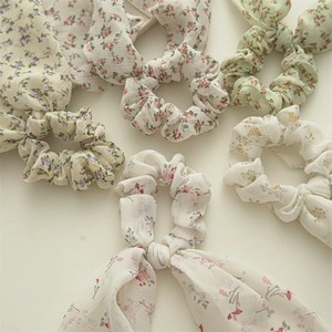 Detailed view of lightweight floral chiffon scrunchies with elegant ribbon streamers