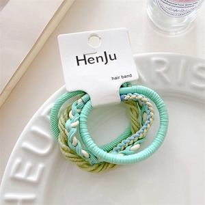 Detail showing high-elastic candy color hair ties in mint green and cream white colors