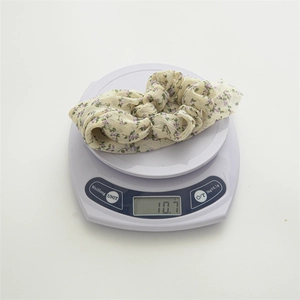 Weight measurement of 10.7g for this lightweight floral chiffon scrunchie accessory