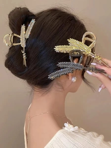 Detail of elegant wheat-shaped alloy hair claw clip with rhinestones in multiple colors