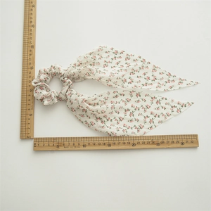 Detailed view of floral scrunchie with ribbons showing dimensions of 22cm on ruler