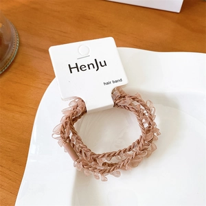 Detail of pink ruffled hair bands with high-elasticity displayed on a white card