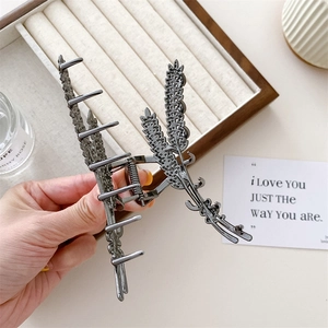 Detail of gun-black metal hair claw clip featuring an elegant double wheat ear design