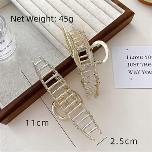 Luxurious gold wheat ear hair claw clips with rhinestones on beige velvet jewelry tray