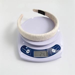 Lightweight sponge padded headband weighing 24.1g with pleated fabric and handmade label