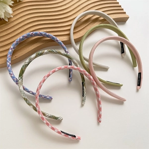 Detail view of 6-piece plaid and solid color fabric headbands with handmade labels