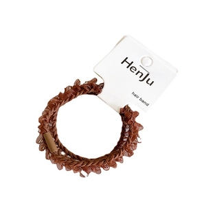 Brown chiffon hair tie set with ruffle edges and cylindrical clasp on display card
