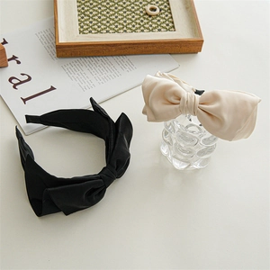 Elegant large satin bow headband set in black and champagne for chic women's hair styling
