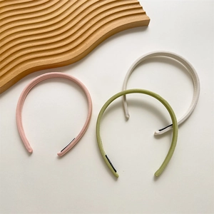 Close-up of pink, olive green and beige plaid headbands with non-slip protective tips