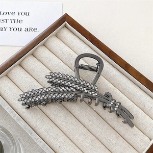 Close-up of wheat-shaped claw clip with sparkling rhinestones in a gunmetal finish