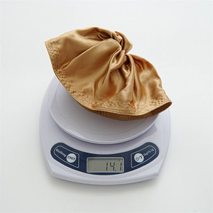 Lightweight 14.1g coffee brown satin scrunchie shown on a digital scale for weight display
