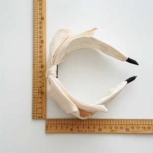 Champagne satin wide knotted headband for women with soft silk luster and 13cm diameter