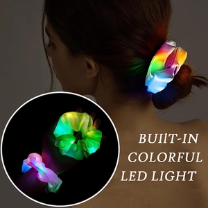 Detail view of shiny satin hair scrunchie with built-in colorful glowing LED lights