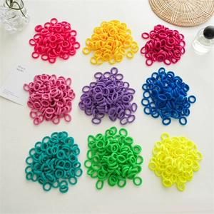 Flat lay of colorful seamless elastic hair ties arranged in a neat nine-grid layout