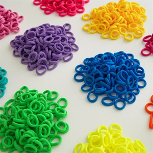 Macro shot of colorful seamless elastic hair ties arranged in vibrant mixed color piles