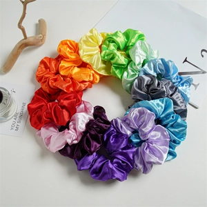 Detailed set of twelve colorful LED satin hair scrunchies arranged in rainbow shades