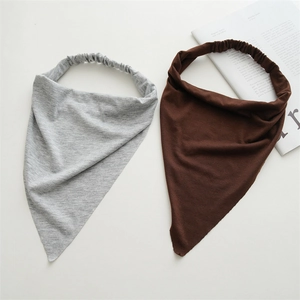 Detailed close-up of grey and brown cotton knit triangle headbands with elastic bands