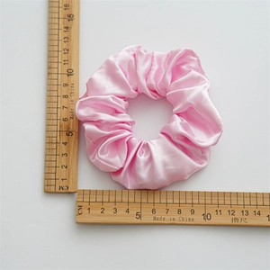 Pink LED satin silk scrunchie for women with 11cm diameter measurement on white background
