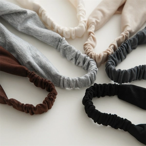 Detail view of elastic band on cotton headbands in brown, grey, and beige tones