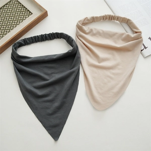Detail of cotton triangle headscarf showing elastic band and soft fabric texture