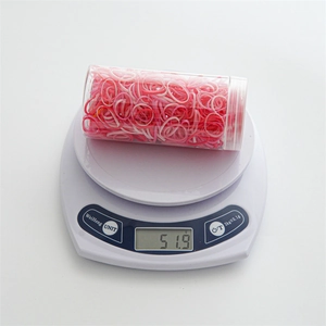 Pink and white elastic hair bands set in transparent jar weighing 51.9g on scale
